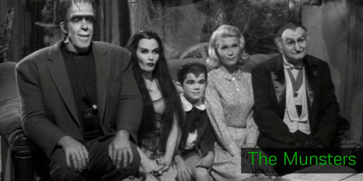 The Munsters movie poster with the monster family in front of a large house