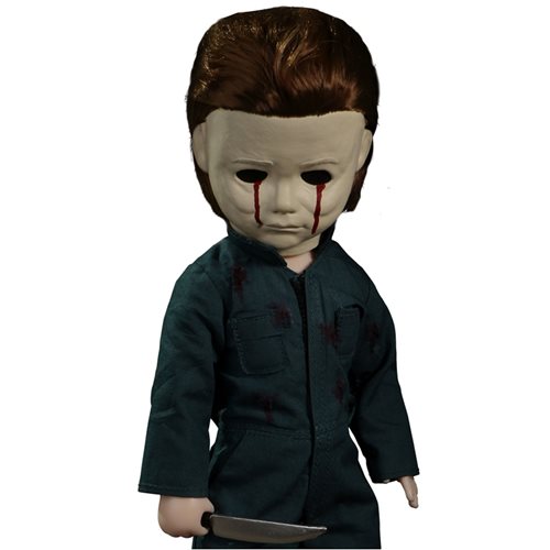 This is a Halloween II Michael Myers Living Dead Doll that is standing in a hospital and he has blood tears coming out of a white mask and is holding a knife while wearing green coveralls