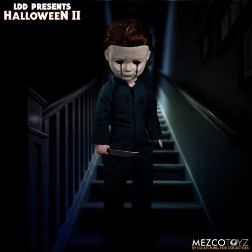 This is a Halloween II Michael Myers Living Dead Doll that is standing in a house and he has blood tears and is holding a knife