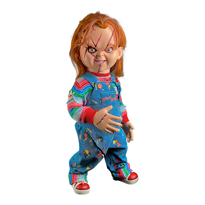 This is a Seed of Chucky life sized doll and he has blue overalls, striped shirt, orange hair, scars and stitches on his face and red shoes. 